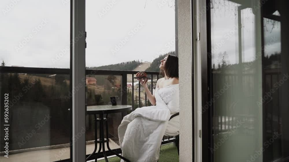 Mountain Balcony Retreat: Woman Savoring Coffee and Croissant Mountain Balcony Retreat: Woman Savoring Coffee and Croissant