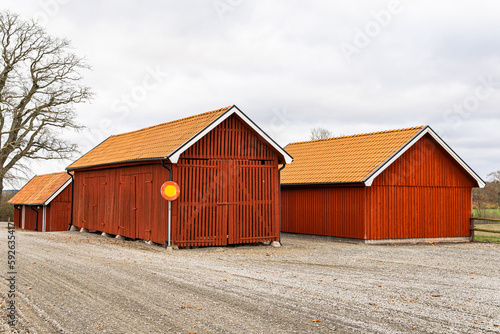 Old red wooden house in vintage Scandinavian style. Traditional ancient Sweden building in the village. A big farm.