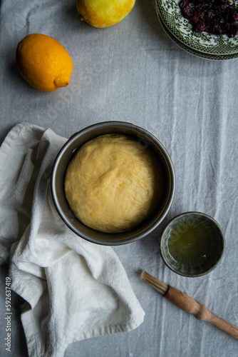 Step by step process of making sweet Ukrainian Easter bread paska. Paska rising in a special springform pan before baking in oven. photo