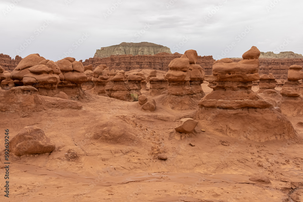 Scenic view on amazing eroded Hoodoo Rock Formations at Goblin Valley State Park in Utah, USA, America. Sandstone rocks called goblins which are mushroom-shaped rock pinnacles. Overcast day in summer Scenic view on amazing eroded Hoodoo Rock Formations at Goblin Valley State Park in Utah, USA, America. Sandstone rocks called goblins which are mushroom-shaped rock pinnacles. Overcast day in summer