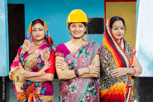 confident young indian female engineer wearing helmet, woman empowerment. feminism employment, Industrial factory workers. Skill india., Career and job opportunities, Aspiration, Dreams. 
