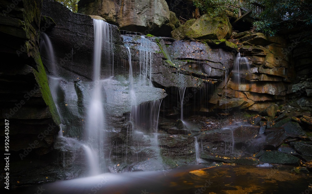 Fototapeta premium Small waterfall flowing over the rocks