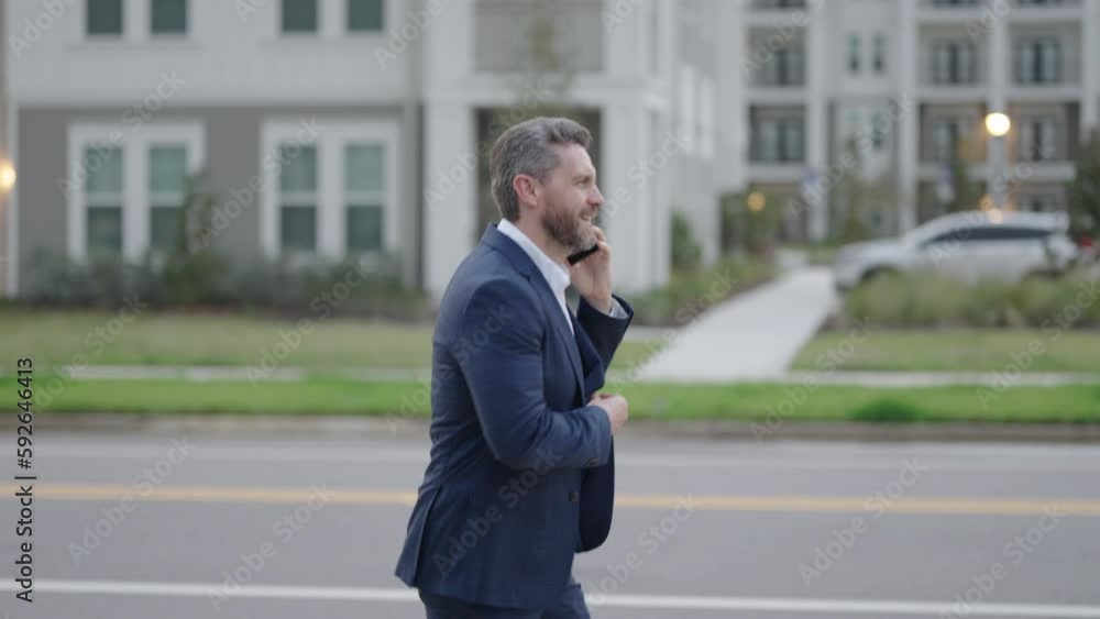 Late business meeting. Worried businessman on the way to office. Man in suit in a hurry, calling phone and running. Urgent news. Middle aged business man hurry late and talking on phone. Slow motion. Late business meeting. Worried businessman on the way to office. Man in suit in a hurry, calling phone and running. Urgent news. Middle aged business man hurry late and talking on phone. Slow motion.