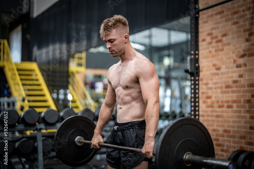 Man doing barbell exercise at gym during weight lifting workout