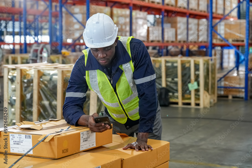Multiethnic industrial workers checking their logistic lists while working with transportation of goods in warehouse Multiethnic industrial workers checking their logistic lists while working with transportation of goods in warehouse