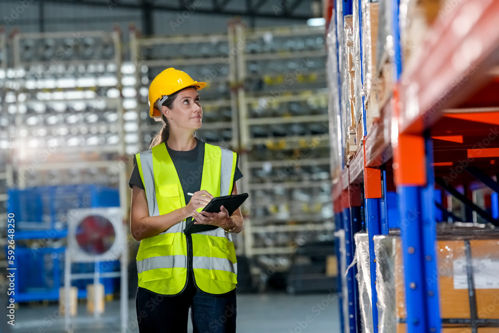 woman worker or supervisor controlling stock in a warehouse. woman worker or supervisor controlling stock in a warehouse.