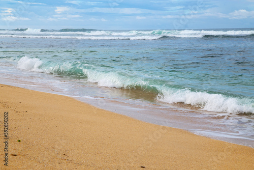 Beautiful seascape with sea waves on the sandy beach 