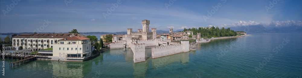 Aerial view of the city of Sirmione, Italy. Panoramic view of Lake Garda. Panoramic aerial view to the town of Sirmione, Scaligero Castle, popular travel destination on Lake Garda in Italy.