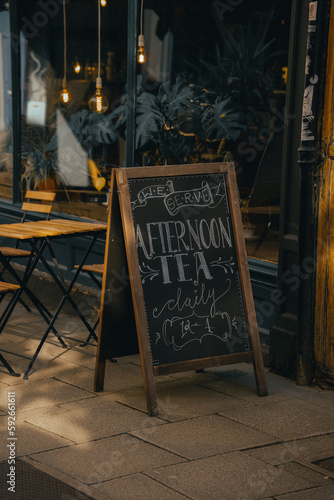 Cuadro en lienzo Afternoon tea cafe A frame A board advertising chalk board outside a restaurant eatery business
