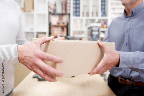 Unrecognizable hands picking up online parcel in a retail store