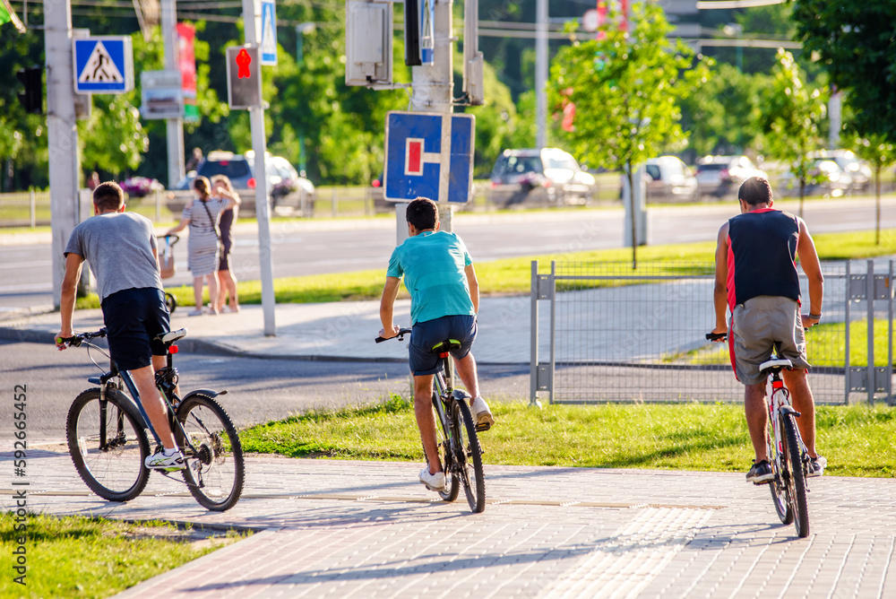 Fototapeta premium Cyclists ride on the bike path in the city Park