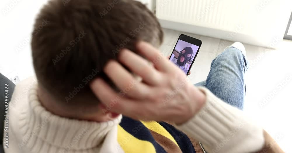Man communicating with internet scammer on mobile phone via video link and showing bank card 4k movie. Fraud online concept Man communicating with internet scammer on mobile phone via video link and showing bank card 4k movie. Fraud online concept