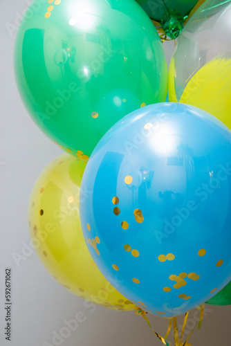 green, yellow and blue balloons on a white background