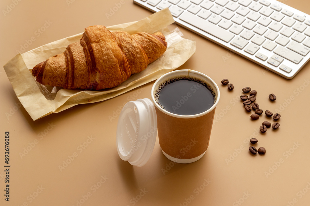 Coffee break in the office. Paper cup of coffee with keyboard, top view Coffee break in the office. Paper cup of coffee with keyboard, top view