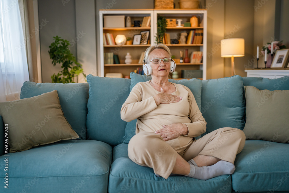 Mature senior woman practice guided meditation manifestation at home Mature senior woman practice guided meditation manifestation at home