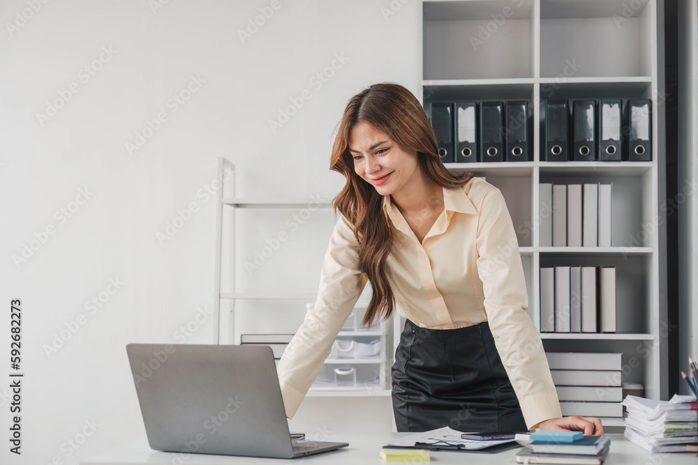 Business woman using calculator for do math finance on wooden desk in office and business working background, tax, accounting, statistics and analytic research concept..