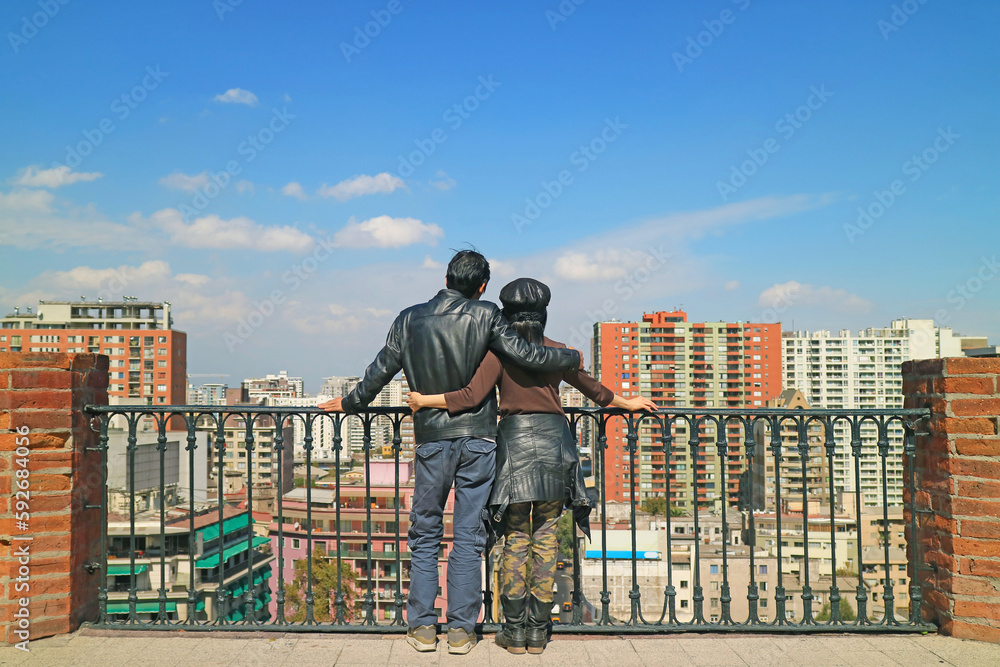 Couple Enjoy the Impressive Aerial View of Santiago City at the View Point of Santa Lucia Hill, Chile, South America Couple Enjoy the Impressive Aerial View of Santiago City at the View Point of Santa Lucia Hill, Chile, South America