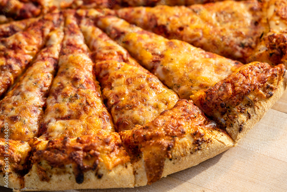 Closeup of a. delicious pizza being Served at a buffet for an outdoor social event. Closeup of a. delicious pizza being Served at a buffet for an outdoor social event.