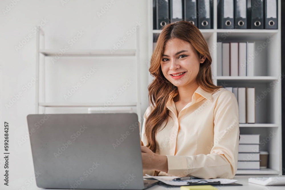 Business woman using calculator for do math finance on wooden desk in office and business working background, tax, accounting, statistics and analytic research concept.. Business woman using calculator for do math finance on wooden desk in office and business working background, tax, accounting, statistics and analytic research concept..