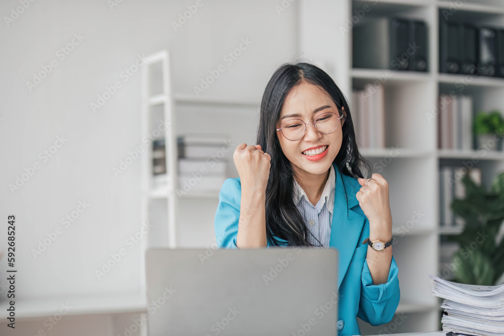 Beautiful Asian girl celebrate with laptop, success happy pose. E-commerce, university education, internet technology, or startup small business concept. Modern office or living room with copy space Beautiful Asian girl celebrate with laptop, success happy pose. E-commerce, university education, internet technology, or startup small business concept. Modern office or living room with copy space