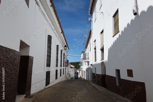 Fototapeta Naklejka Na Ścianę i Meble -  Castano del Robledo, Huelva, Spain, April 2, 2023: Street with whitewashed houses of Castano del Robledo, magical town of Andalusia. Huelva, Spain