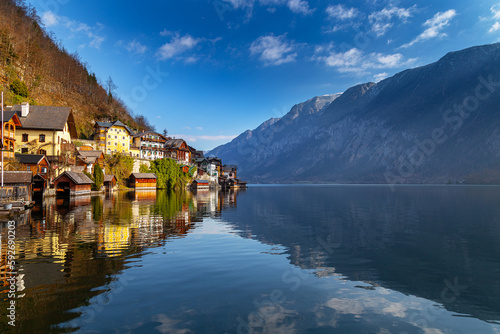 Beautiful small village of Hallstatt in the Austrian alps on the shore of Hallstatter See. Classic view of Halsstatt with the village and the church tower in the background. © oliverleicher