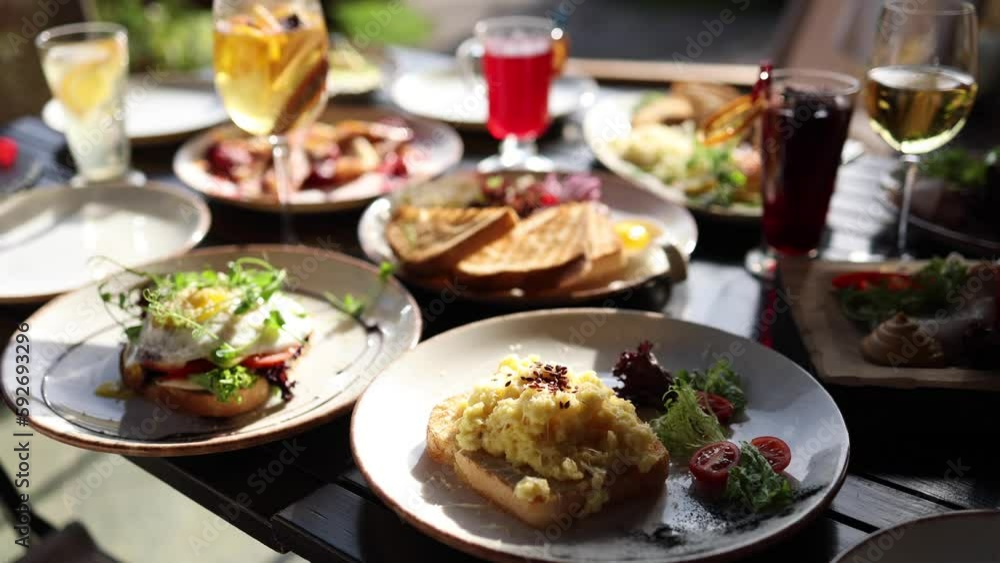 Served table with food and drinks. Restaurant on terrace. Served table with food and drinks. Restaurant on terrace.