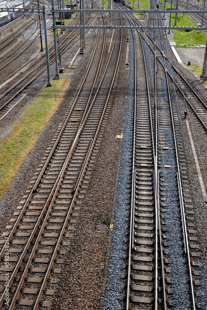 Obraz premium Several empty parallel train tracks in major rail hub in European city. Above view, trains, no people