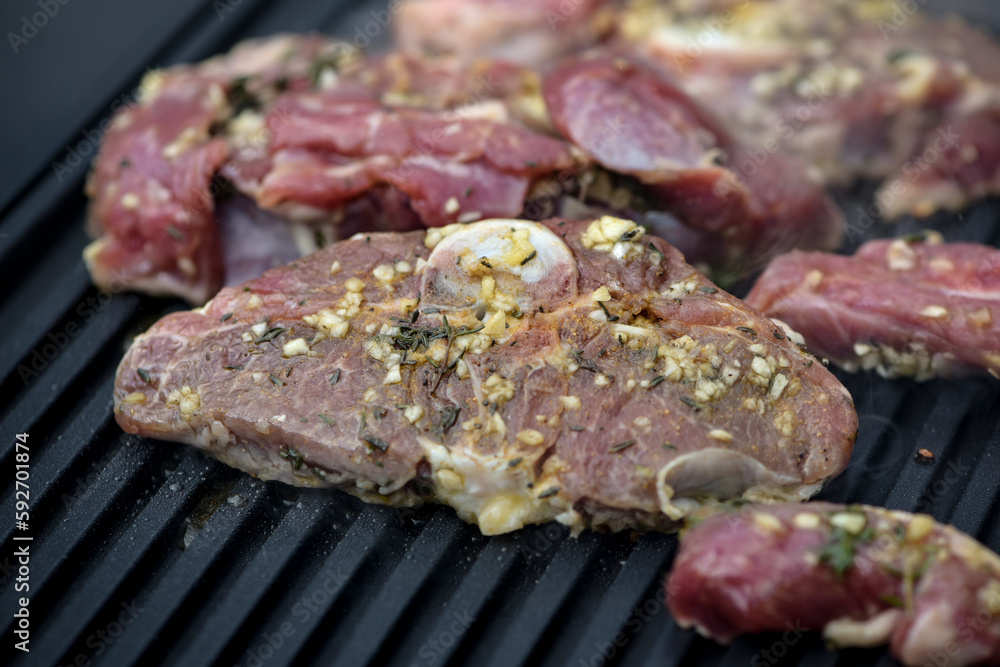 view of lamb being cooked on a griddle