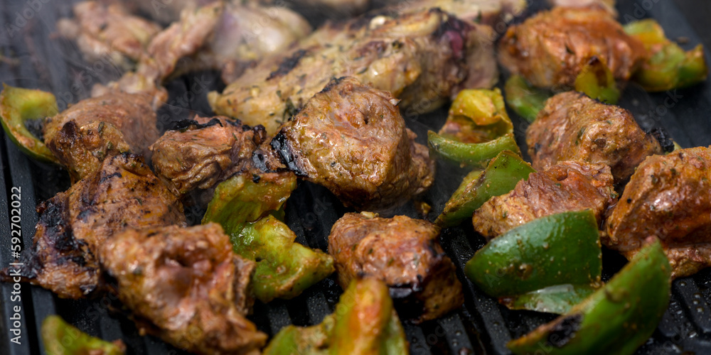 view of beef being cooked on a griddle view of beef being cooked on a griddle