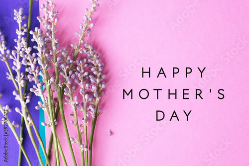 Liriope blooms on pink and purple background with mothers day greeting text. photo
