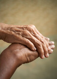 Helping hands, care for the elderly concept, close up with selective focus.