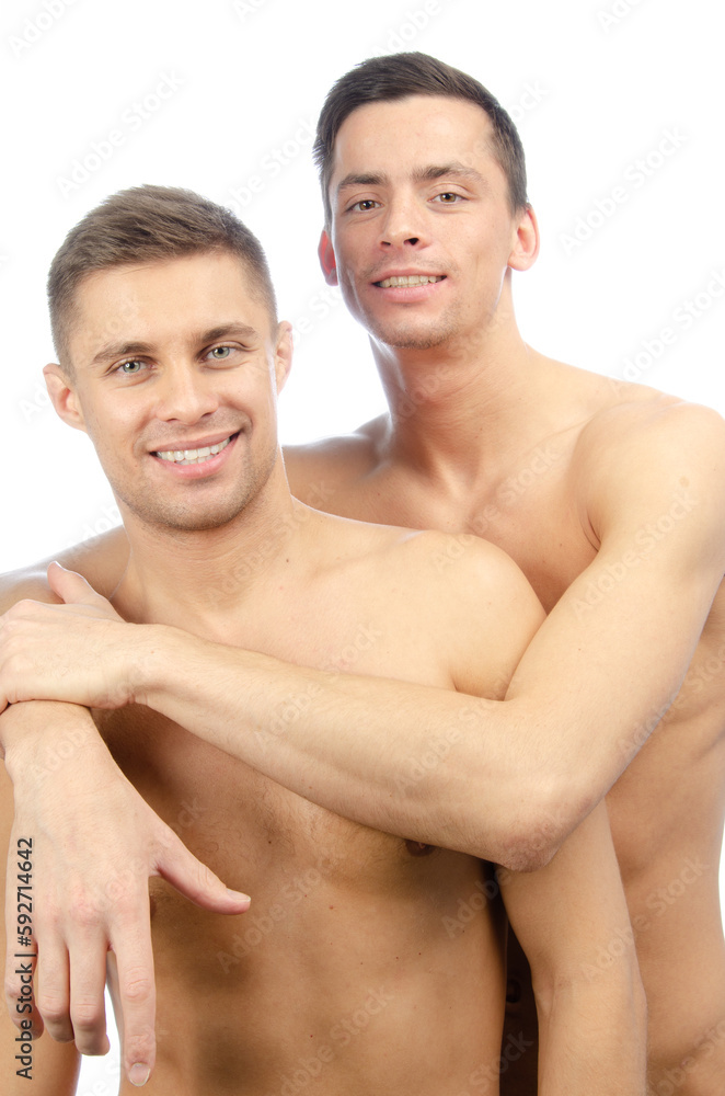 Two young attractive guys are posing in the studio. Beautiful gay couple in a relationship. Love and romance. Two young attractive guys are posing in the studio. Beautiful gay couple in a relationship. Love and romance.