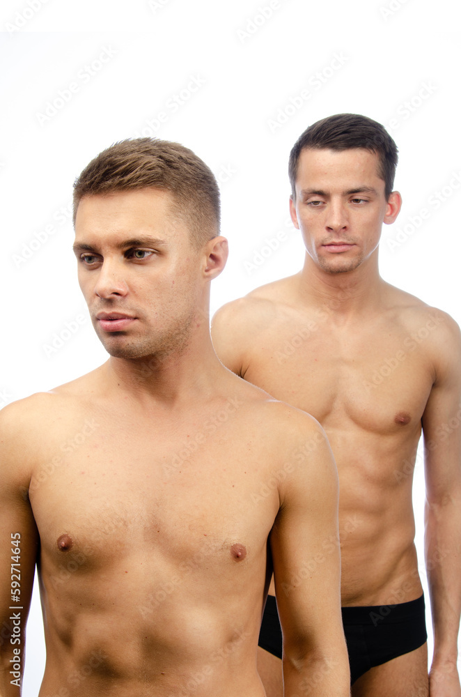 Two young attractive guys are posing in the studio. Beautiful gay couple in a relationship. Love and romance. Two young attractive guys are posing in the studio. Beautiful gay couple in a relationship. Love and romance.