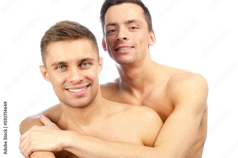 Two young attractive guys are posing in the studio. Beautiful gay couple in a relationship. Love and romance. Two young attractive guys are posing in the studio. Beautiful gay couple in a relationship. Love and romance.