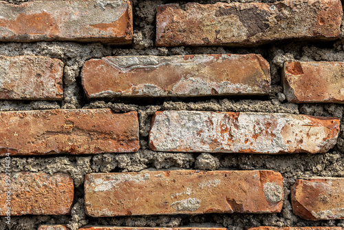Fragment of an old red brick wall