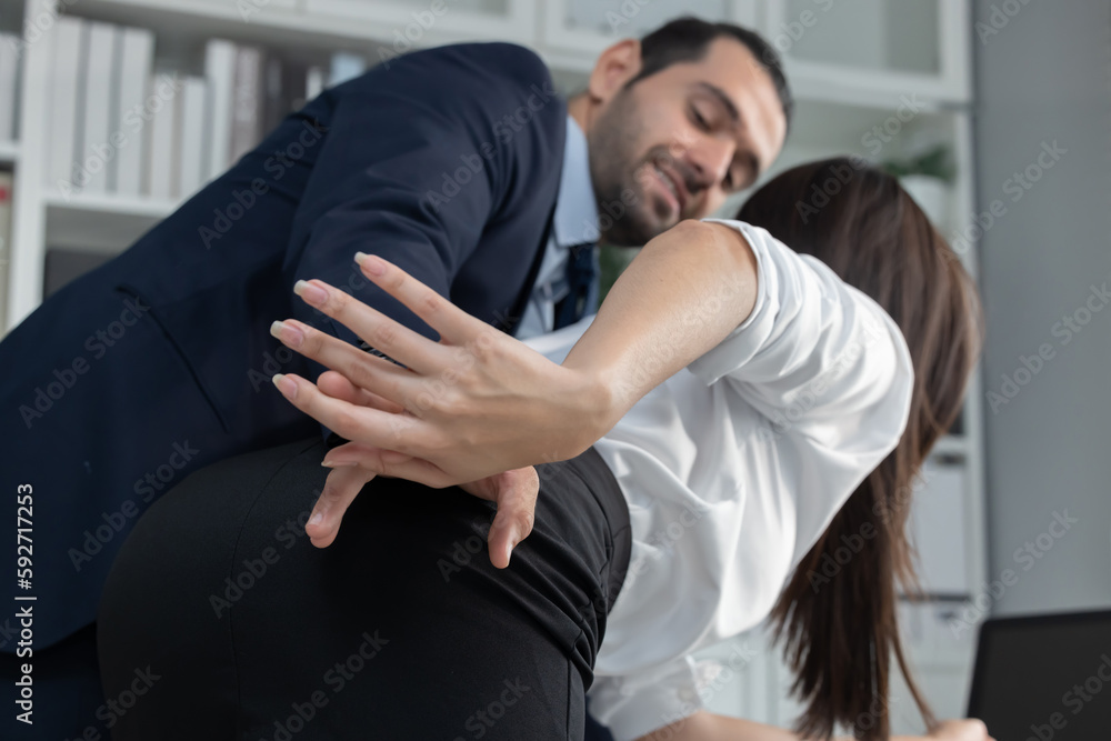 Caucasian Businessman Molesting his Female Colleague by Touching her Hips Caucasian Businessman Molesting his Female Colleague by Touching her Hips