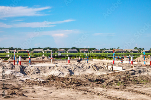 Residential lot with utility connectors for construction of a single-family house in a suburban lakeside development in west central Florida