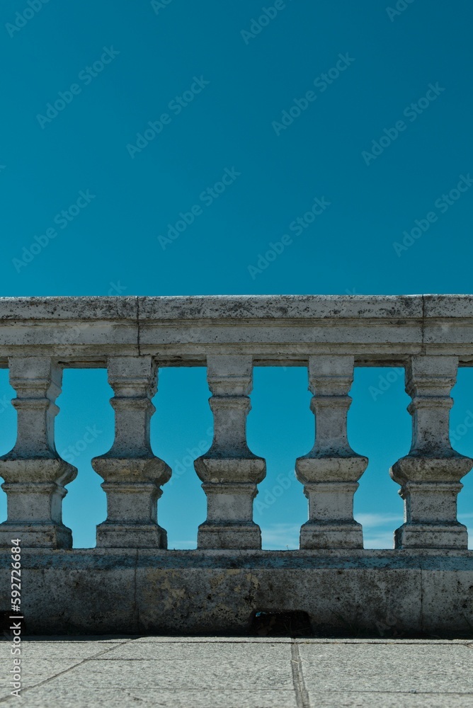 Fototapeta premium Stone railing against a blue sky