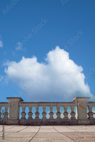 Stone railing against a cloudy sky