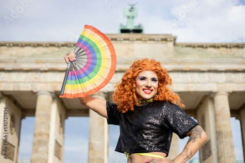 Drag queen with rainbow fan at the Brandenburg Gate in Berlin, Pride month
