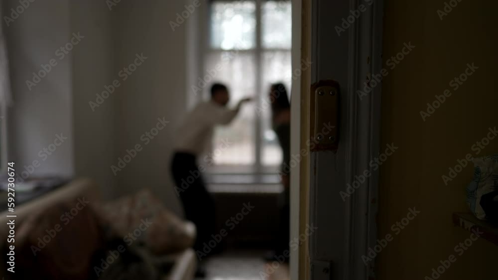 Blurred shot of couple arguing at home. Candid moment of husband and wife fighting each other. Person threatening the other in discussion Blurred shot of couple arguing at home. Candid moment of husband and wife fighting each other. Person threatening the other in discussion