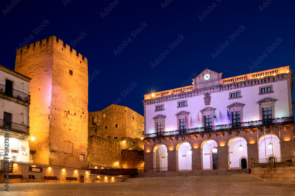 Plaza Mayor de Caceres at dusk with the wall and the town hall in the background