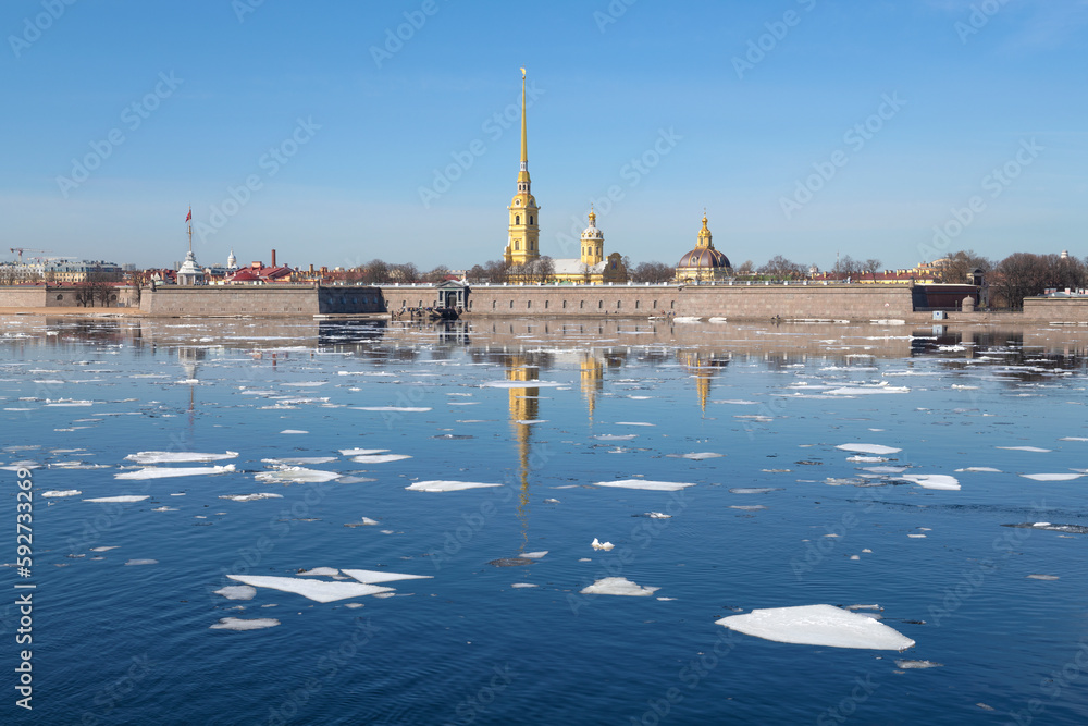 Ice drift on the Neva river against the background of the Peter and Paul Fortress. April in St. Petersburg. Russia