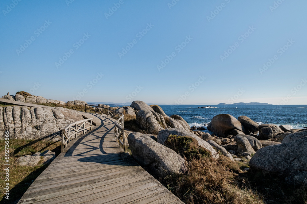 Zigzag wooden walkway in rocky coastline
