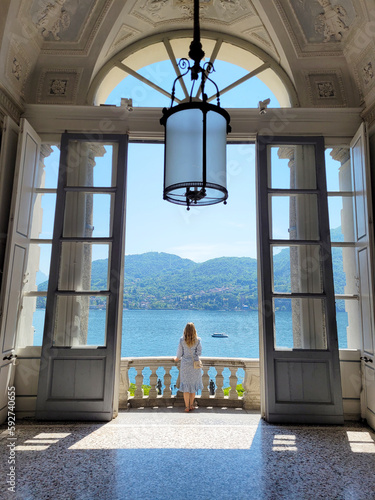 Woman standing on a balcony of Villa Carlotta looking at Lake Como in Tremezzina (Italy) photo