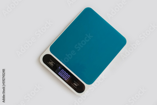 Kitchen scales on a colored background