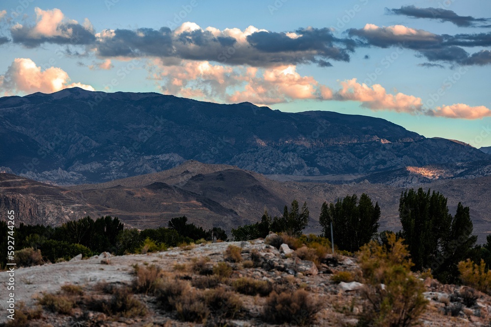 Rocky mountains with the dry grass and trees at dusk in Owens Valley, California