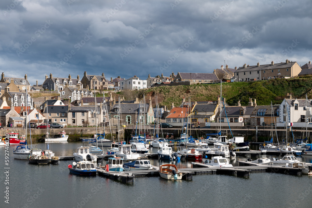 5 April 2023. Findochty Harbour,Moray,Scotland. This is the Harbour and Marina area of the Moray Coast Fishing Harbour with a stormy sky and clouds forming but the sun still shining.