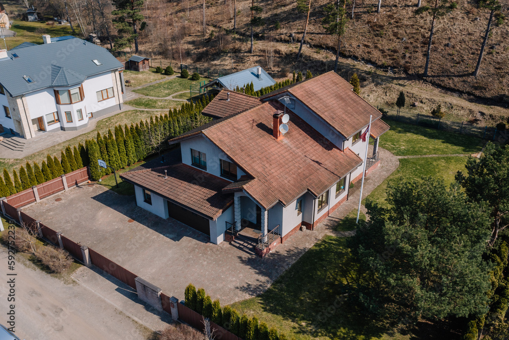 Gray private house with a red roof in a residential area Gray private house with a red roof in a residential area
